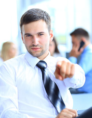 Portrait of smiling mature business man pointing at you