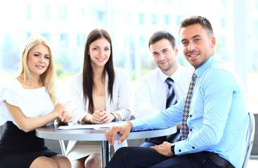 business man with colleagues at a conference in the background