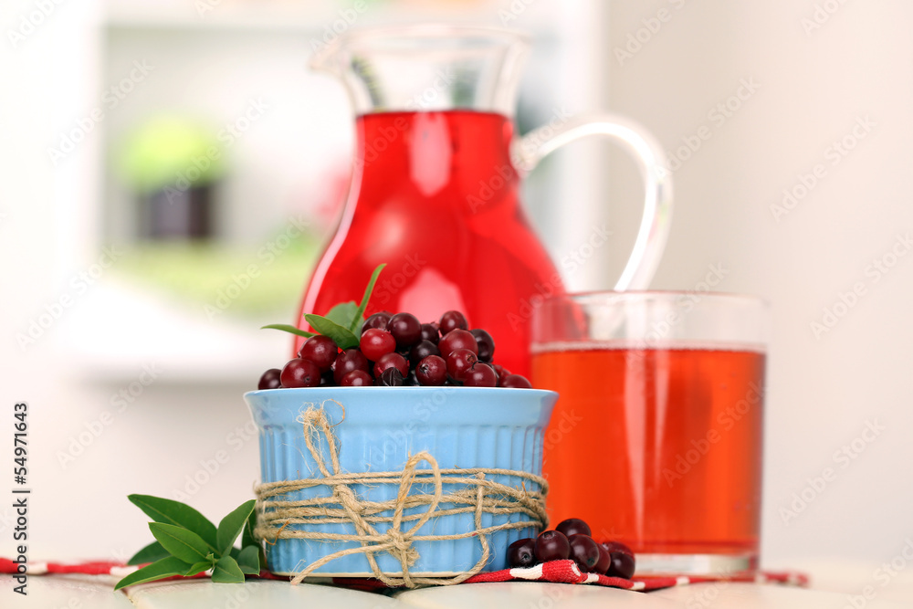 Pitcher and glass of cranberry juice with red cranberries