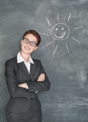 Wall Mural - Happy teacher and smiling sun on the chalkboard