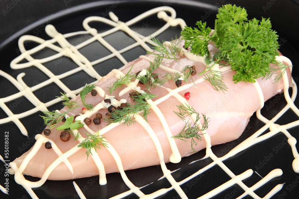 Raw chicken fillets on dripping pan, close-up