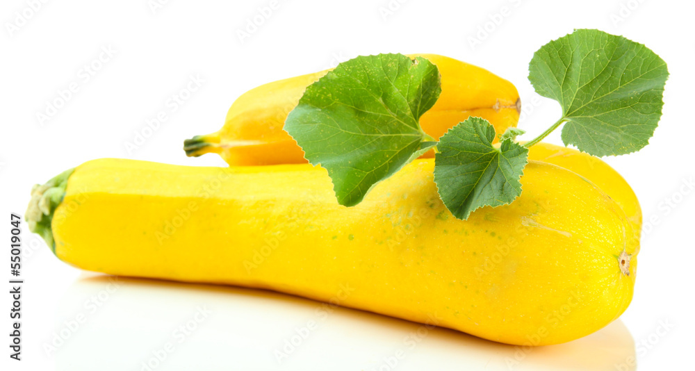 Raw yellow zucchini with leaves, isolated on white