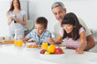 © WavebreakmediaMicro - Cute family eating breakfast in kitchen together