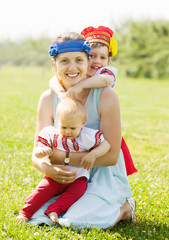 happy  woman with  children in russian folk clothes