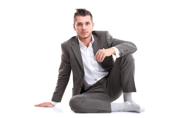 Wall Mural - Portrait of business man sitting on the floor isolated