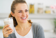 Smiling Young Woman Drinking Fresh Cocktail