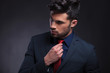 © Viorel Sima - business man fixing his tie and looking away