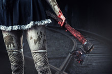Dirty Woman's Hand Holding A Bloody Axe