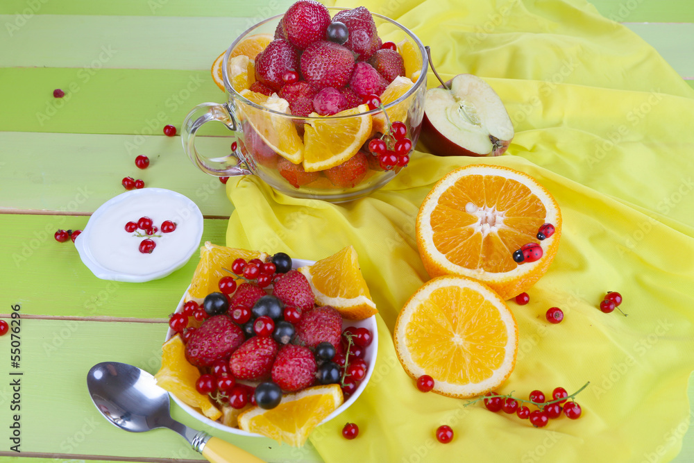 Useful fruit salad in glass cup and bowl