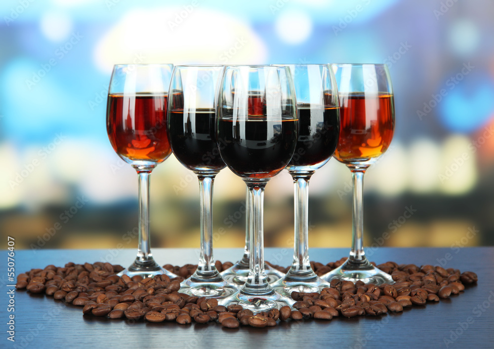 Glasses of liquors, on bright background