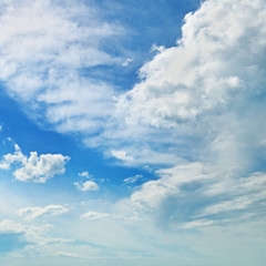 The white cumulus clouds against the blue sky