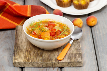 Wall Mural - Bowl of tomato and pepper soup on wooden table. Autumn setting.