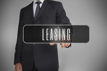 Businessman Selecting Label With Leasing Written On It