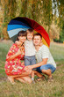 © Vitalinka - Father, mother and son with colorful umbrella.