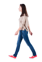 Wall Mural - back view of walking  woman in jeans .