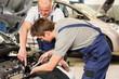 © CandyBox Images - Caucasian car mechanics working together