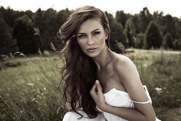 Vogue style portrait of young woman on meadow