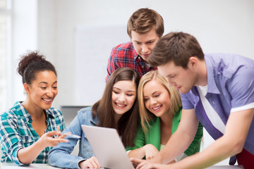 Wall Mural - international students looking at laptop at school
