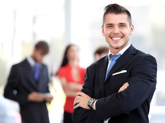 Wall Mural - Happy smart business man with team mates discussing