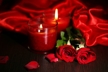 beautiful romantic red candle with flowers and silk cloth,