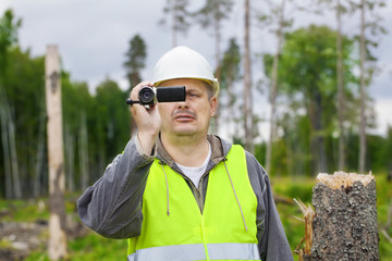 Sticker - Forest Officer with camcorder in destroyed forest