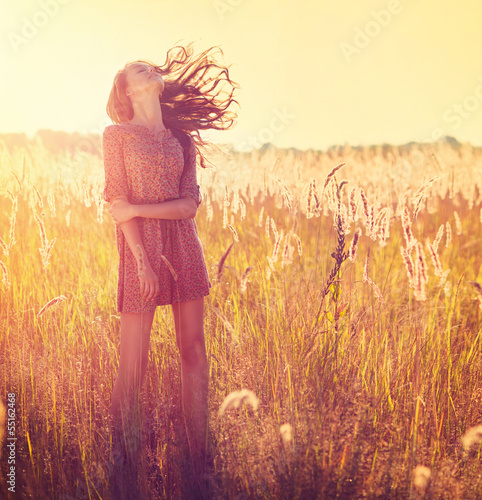 Fototapeta na wymiar Beauty Girl Outdoor. Teenage Model Girl Posing in Sun Light