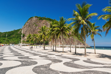Fototapete - Copacabana with palms and mosaic of sidewalk in Rio de Janeiro