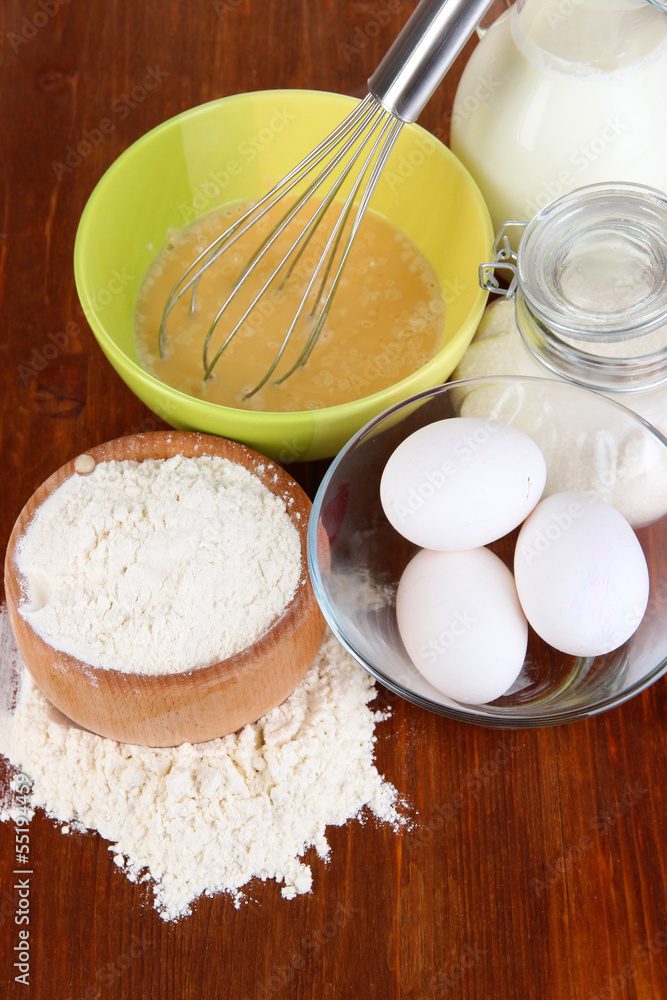 Ingredients for dough on wooden table close-up
