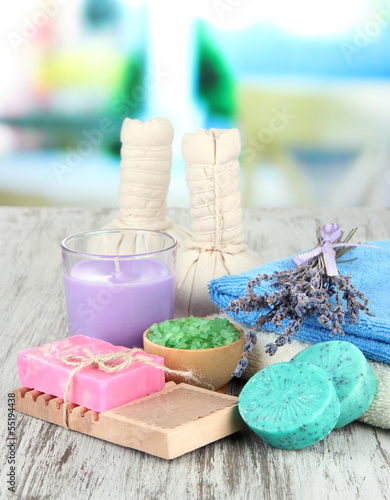 Fototapeta na wymiar Still life with lavender candle, soap, massage balls, bottles,