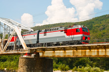 Train Rides Over Bridge Across Mountain River