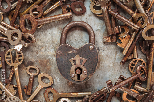 Fototapeta na wymiar Vintage rusty padlock surrounded by old keys