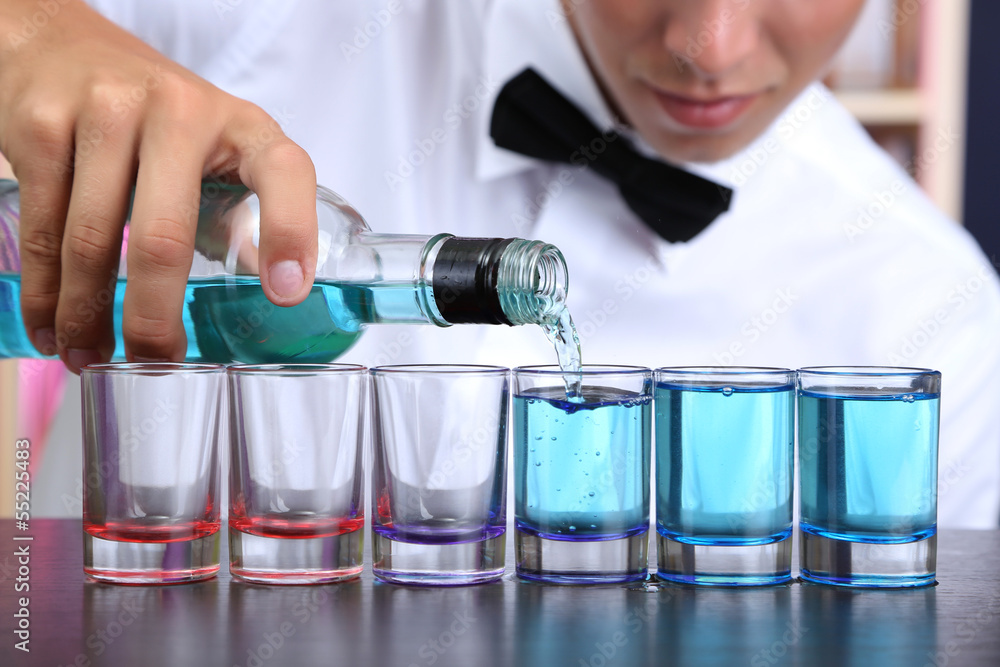 Bartender is pouring liquor into glass