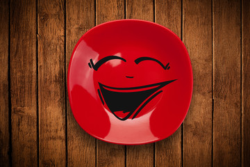 Happy smiley cartoon face on colorful dish plate