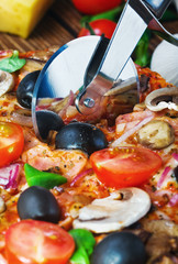 Wall Mural - cutter cuts a fresh pizza with mushrooms