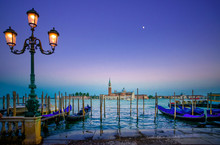 Venice, Street Lamp And Gondolas On Sunset And Church. Italy