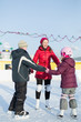 © Pavel Losevsky - A mother with children are skating on outdoor skating rink