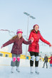 © Pavel Losevsky - Happy mother and daughter are skating at the outdoor skating rin