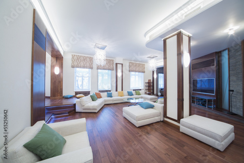 The Spacious Well Lit Living Room With Round Glass Table