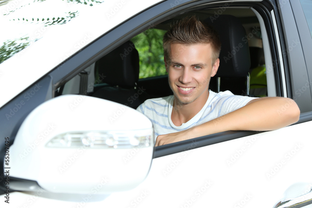 Young man in his new car