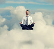 © ArtFamily - man in formal wear meditating in the sky
