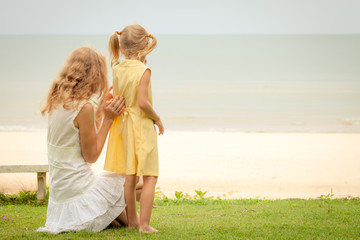 mother and her daughter at the beach