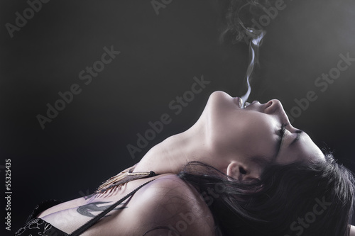 Fototapeta na szkło Smoking, tattoed woman with smoke flame