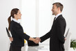 © BlueSkyImages - Dishonest partnership. Two young business people shaking hands a