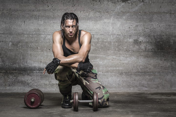 Wall Mural - portrait of sweaty athlete resting from weight training