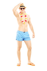 Wall Mural - Full length portrait of a handsome guy in swimming shorts