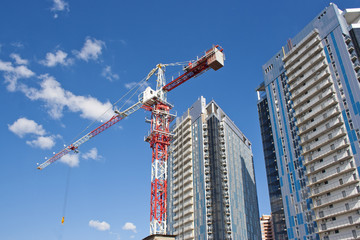 building crane on a background of high-rise buildings