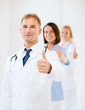 © Syda Productions - doctor with stethoscope and colleagues