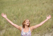 Carefree woman standing with arms outstretched