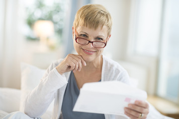 Wall Mural - Smiling Mature Woman Holding Envelope