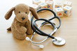 Leinwandbild Motiv Pediatrics. Puppy toy with medical equipment